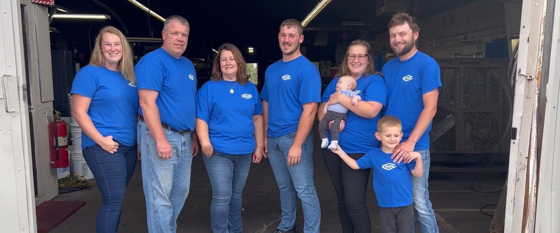 The Graetz Mfg., Inc. family and team in matching blue company shirts